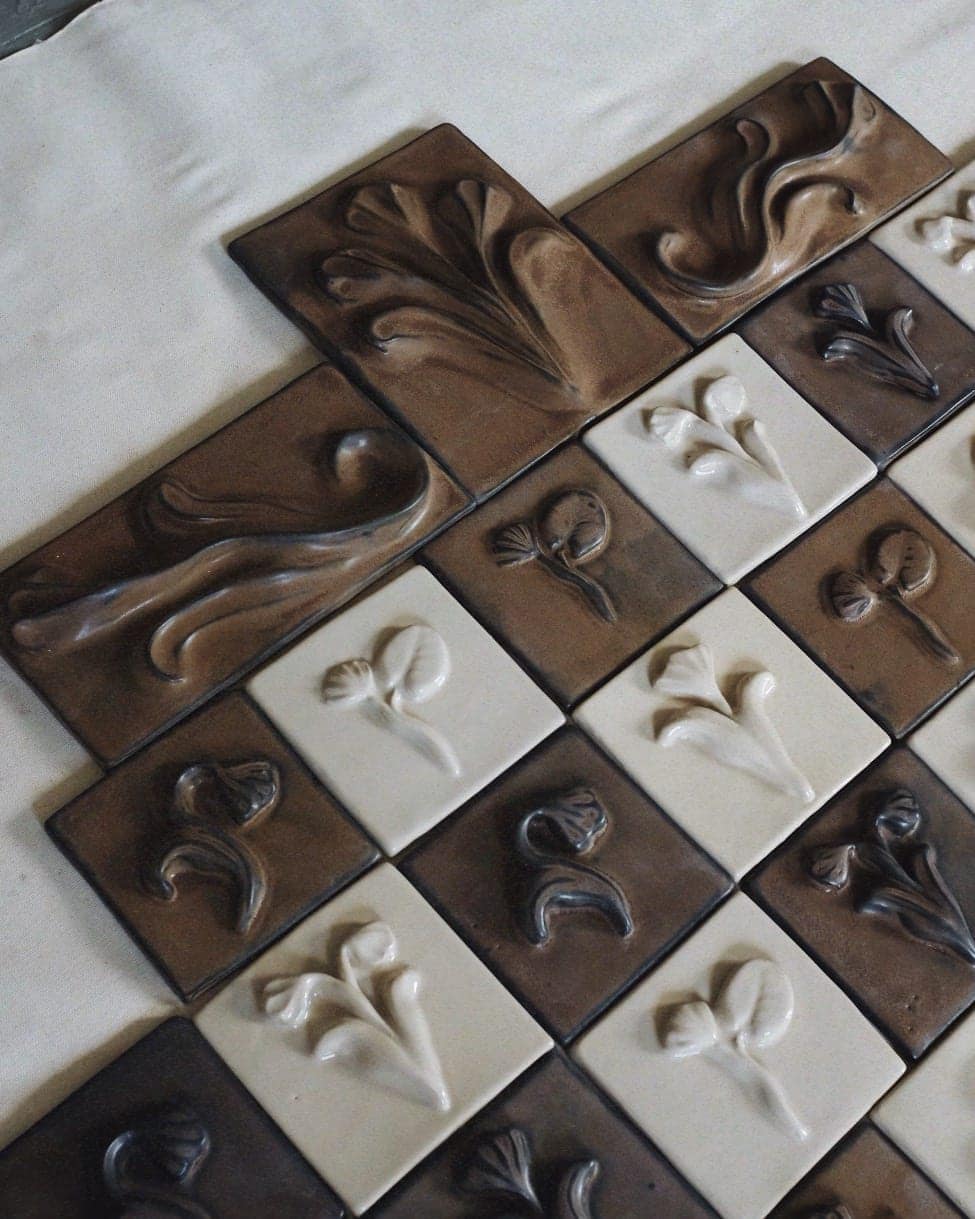 Glazed relief tiles in brown and cream laid in a chequered arrangement